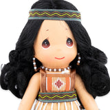 Close up of the face of the doll with her traditional Maori headband and earings