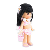 Side angle of the doll and her swim suit as well as her small pink beach bag
