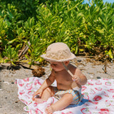 Toddler on Little Unicorn Cotton Muslin Swaddle Blanket- Pitaya/Dragon Fruit Design