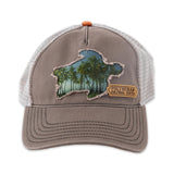 Hat with a turtle cutout and tropical trees inside the outline as well as a tag next to the hat that says Polynesian Cultural Center