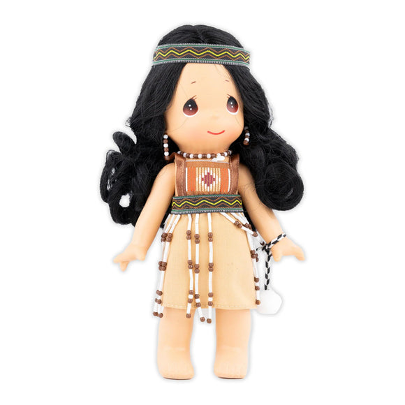 Doll that is wearing traditional maori clothing and has pompons
