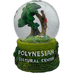 Snow Globe with a man climbing a palm tree and a green base.
