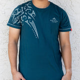 Model wearing Kia Kaha Cotton "Ngaru" Maori Tattoo Men's Tee Shirt- Dark Teal