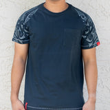 Model wearing Kia Kaha Mens Cotton Raglan "Maorie Tattoo" Tee Shirt- Dark Teal