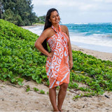 Model wearing Orange and white Tahiti Turtle print sarong