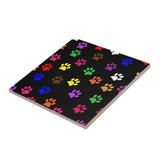 Square trivet designed with colorful dog paws.