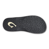 Black rubber sole of OluKai sandal with logo