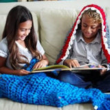 A Child Wearing Childs Mermaid Knit Blanket- Sea Blue