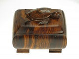 Wooden box with sea turtle carved onto the top of it