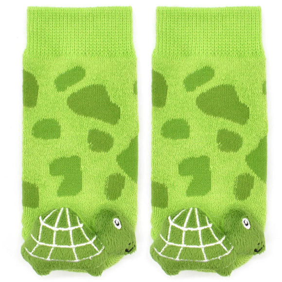 Socks with turtles on the toes that are actually rattles